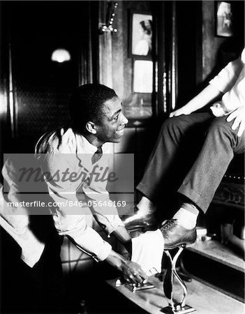 1930s AFRICAN AMERICAN MAN SMILING SHINING SHOES ON SEATED PATRON AT  SHOESHINE STAND - Stock Photo - Masterfile - Rights-Managed, Artist:  ClassicStock, Code: 846-05646169