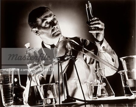 https://image1.masterfile.com/getImage/846-05646171em-1930s-scientist-chemist-holding-up-test-tube-vial-beaker-in.jpg