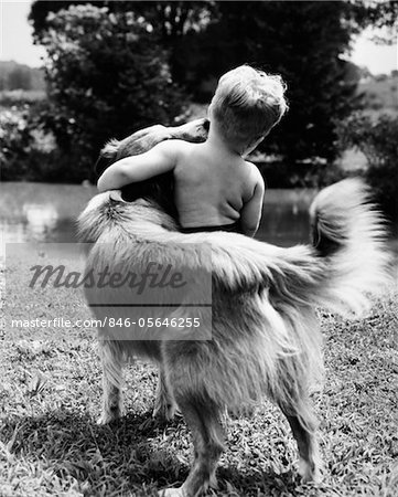 1940s - 1950s - 1960s BACK VIEW OF BOY AND DOG HUGGING