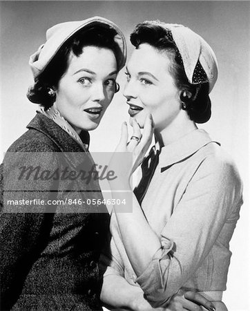 1950s TWO WOMEN WEARING HATS WHISPERING GOSSIP