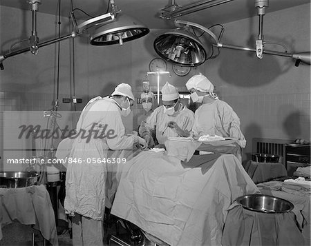 DOCTORS IN OPERATING ROOM OPERATING ON PATIENT