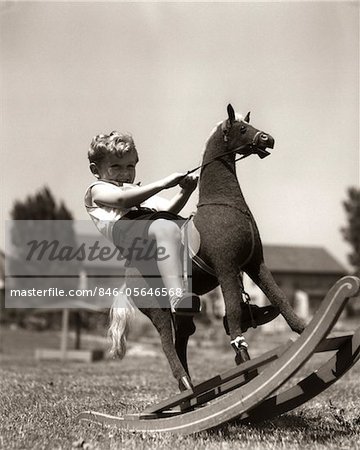 1930s LITTLE BOY OUTSIDE PLAYING RIDING ON TOY ROCKING HORSE
