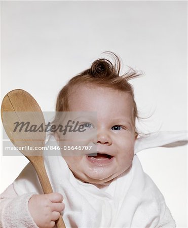 baby holding spoon