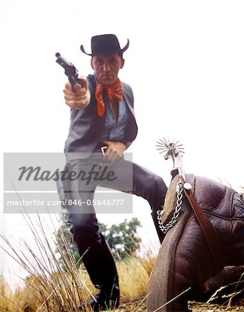 1960s MAN COWBOY IN BLACK HAT SHOOTING GUN DEAD MAN ON GROUND
