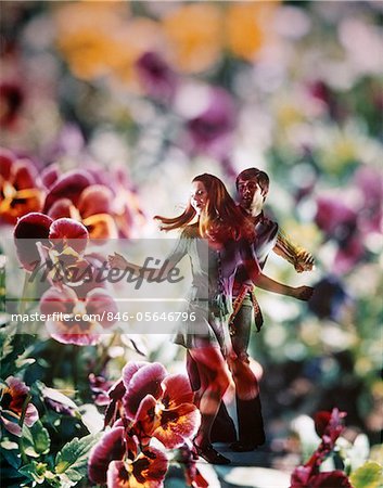1960s - 1970s YOUNG COUPLE DANCING AMONG PANSY FLOWERS SUPERIMPOSED GRAPHIC EFFECT