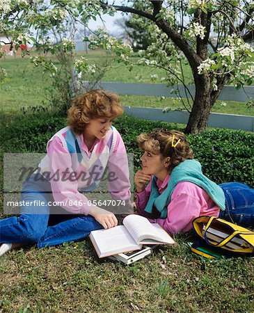 1980 1980s 2 TEENAGE GIRLS SISTERS SIT ON HEARTH READING MAGAZINE