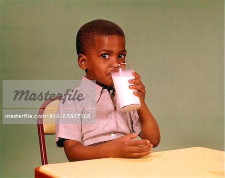 https://image1.masterfile.com/getImage/846-05647265em-1960s-africanamerican-boy-drinking-glass-of-dairy-milk-stock-photo.jpg