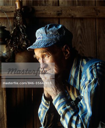1990s PORTRAIT OF ELDERLY MAN IN BLUE AND WHITE STRIPED TRAIN ENGINEERS HAT