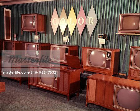 1960s DISPLAY OF COLOR TELEVISION SETS FOR SALE IN DEPARTMENT STORE