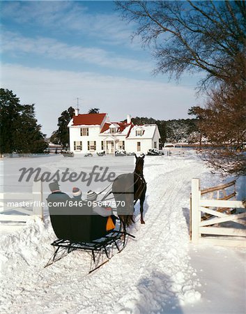 1960s PEOPLE RIDING IN HORSE DRAWN SLEIGH OVER SNOW BOY GIRL MAN SON DAUGHTER FATHER OUTDOOR