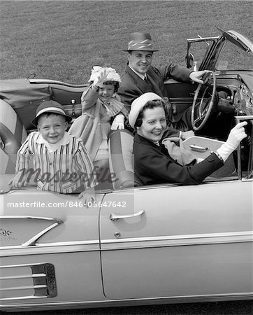 1950s SMILING FAMILY PORTRAIT MOTHER FATHER SON DAUGHTER IN CHEVROLET CONVERTIBLE AUTOMOBILE