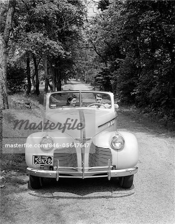 1940s - 1941 COUPLE MAN AND WOMAN IN PONTIAC CONVERTIBLE DRIVING ON COUNTRY LANE IN COUNTRYSIDE