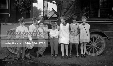 1910s CHILDREN LINED UP IN FRONT OF TRUCK FACING CAMERA