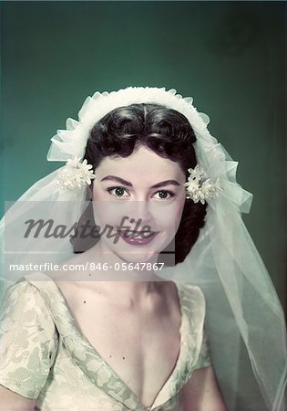 1950s PORTRAIT SMILING WOMAN BRIDE WEARING WEDDING DRESS AND VEIL