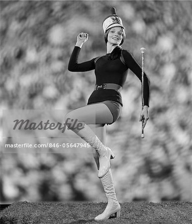 1970s SMILING YOUNG WOMAN MAJORETTE WHITE BOOTS HOT PANTS MARCHING