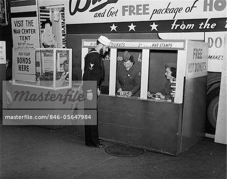 1940s - 1943 SAILOR BUYING WAR STAMPS AT DONUT MOBILE AT BOWLING GREEN NEW YORK CITY