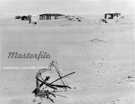 1930s RUINED FARM BEING OVERTAKEN BY ERODED TOPSOIL CREATING A DUST BOWL EFFECT IN AMERICA'S GREAT PLAINS NEAR ELDER COLORADO