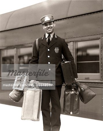 1930s - 1940s PORTRAIT SMILING AFRICAN AMERICAN MAN RED CAP PORTER CARRYING LUGGAGE BAGS SUITCASES PASSENGER RAILROAD TRAIN