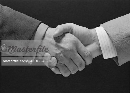 1960s MALE HANDSHAKE