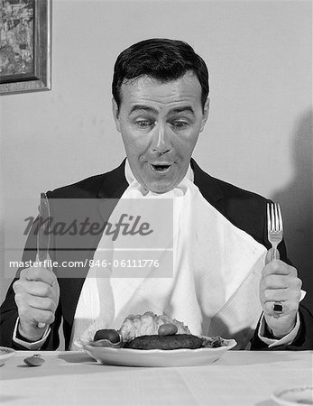 846-06111776em-1960s-man-sitting-at-table-ready-to-eat-dinner-with-napkin-at-neck.jpg