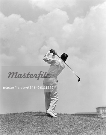 1930s MAN PLAYING GOLF TEEING-OFF GOLF BALL FROM TEE WITH DRIVER OUTDOOR