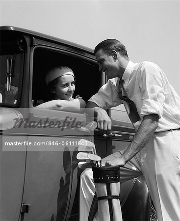 1930s WOMAN IN DRIVER'S SEAT OF CAR LEANING OUT OF WINDOW TALKING TO MAN  STANDING HOLDING GOLF BAG - Stock Photo - Masterfile - Rights-Managed,  Artist: ClassicStock, Code: 846-06111843