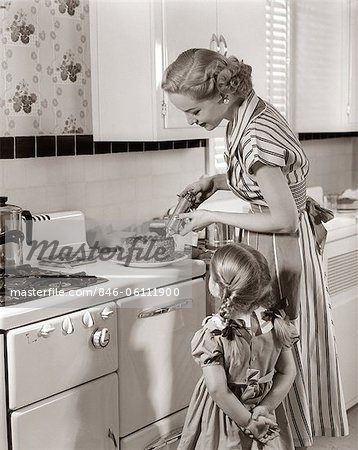 1950s HOUSEWIFE IN KITCHEN DECORATING CAKE ON STOVE WITH PASTRY GUN WHILE  LITTLE DAUGHTER WATCHES - Stock Photo - Masterfile - Rights-Managed,  Artist: ClassicStock, Code: 846-06111900