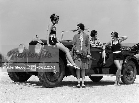 Happy 1920s Dressed Girl Holding Suitcase Next To Vintage Car