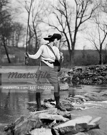 1920s WOMAN IN HAT WITH FISHING NET & TACKLE BAG STRAPPED TO HER