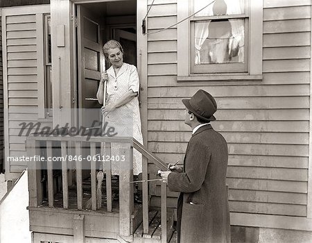 1940s 1930s Man Door To Door Salesman Talking Woman To Housewife