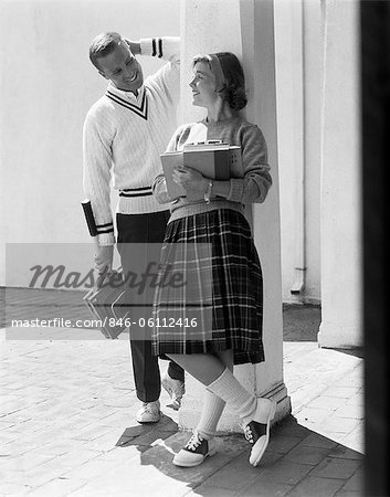 1950s 1960s COLLEGE HIGH SCHOOL AGED TEENAGE BOY & GIRL SMILING FLIRTING WEARING SADDLE SHOES PLAID PLEATED SKIRT TENNIS SWEATER