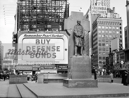 1940s BUY DEFENSE BONDS BILLBOARD AT STATUE OF FATHER DUFFY OF THE FIGHTING 69th OF WORLD WAR I AT TIMES SQUARE NEW YORK CITY