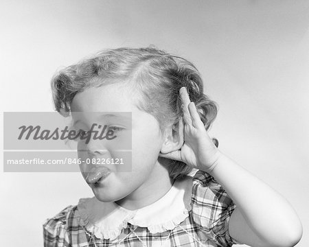 1950s LITTLE GIRL MAKING RUDE GESTURE STICKING OUT TONGUE CUPPING HAND ON EAR