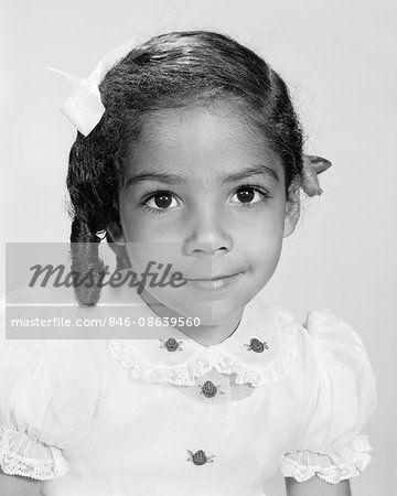 1960s PORTRAIT PRETTY AFRICAN AMERICAN GIRL SMILING LOOKING AT CAMERA