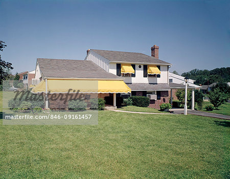 1960s 1970s SUBURBAN HOME RESIDENTIAL NEIGHBORHOOD WHITE WITH BLACK SHUTTERS YELLOW AWNINGS FRONT LAWN