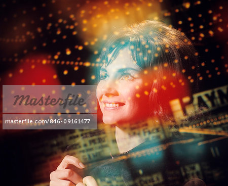 1970s COMPOSITE OF PORTRAIT OF SMILING STARRY EYED BRUNETTE AND MULTIPLE EXPOSURES OF MARQUEE LIGHTS