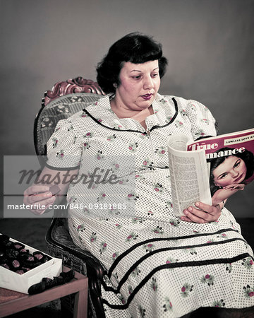 1950s Obese Overweight Woman Sitting Eating Box Of Chocolate Candy