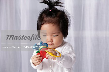 Chinese Baby Holding Toy Key Ring Stock Photo Masterfile Rights