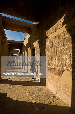 Woman walking along West Colonnade,Temple of Isis,Philae Island near Aswan,Egypt