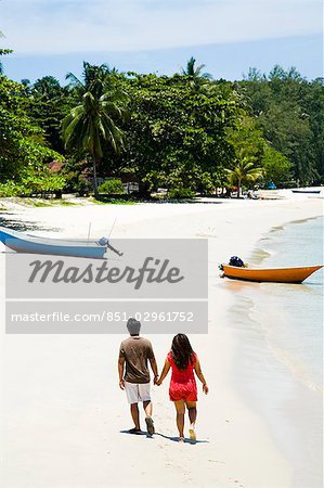 Couple walking hand-in-hand along beach,Kapas island,Terengganu,Malaysia