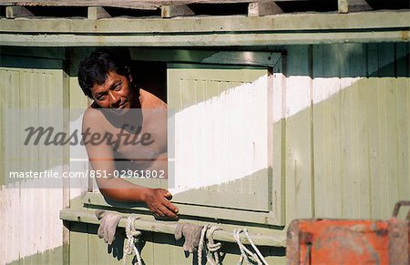 man looking out of local fishing boat,malaysia