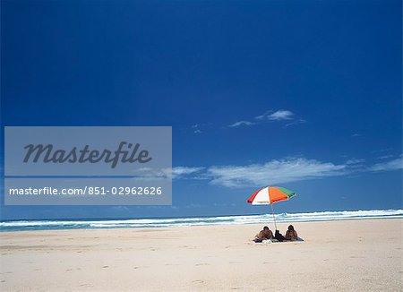 Couple under beach umbrella,Western Cape,Republic of South Africa