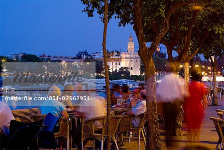 People in outdoor restaurant at dusk,Seville,Andalucia,Spain