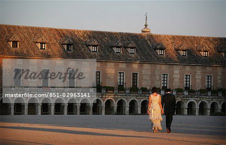 Couple walking in grounds of Royal Palace in Aranjuez at dusk,Madrid,Spain