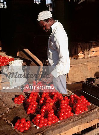 Man in market with tomatoes,Stone Town,Zanzibar Island. Tanzania