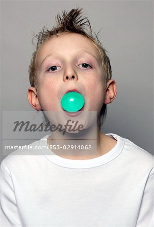 Boy making chewing gum bubble