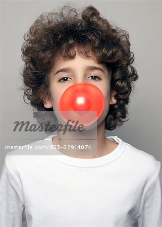 Boy making chewing gum bubble