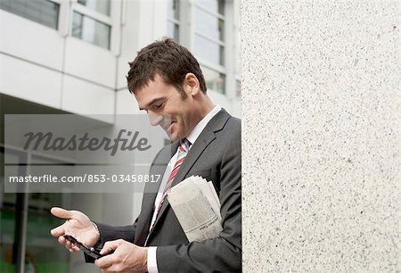 Businessman using mobile phone, waist up