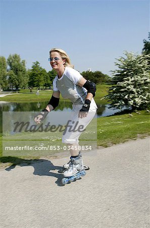 Senior woman inline skating, high size