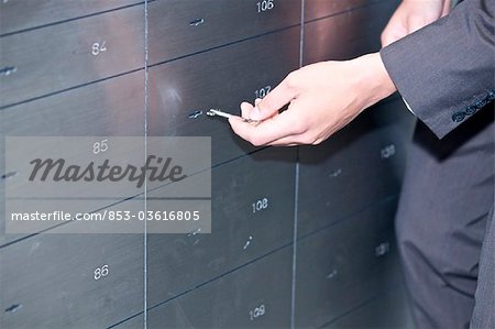 Man opening safe deposit box, close-up